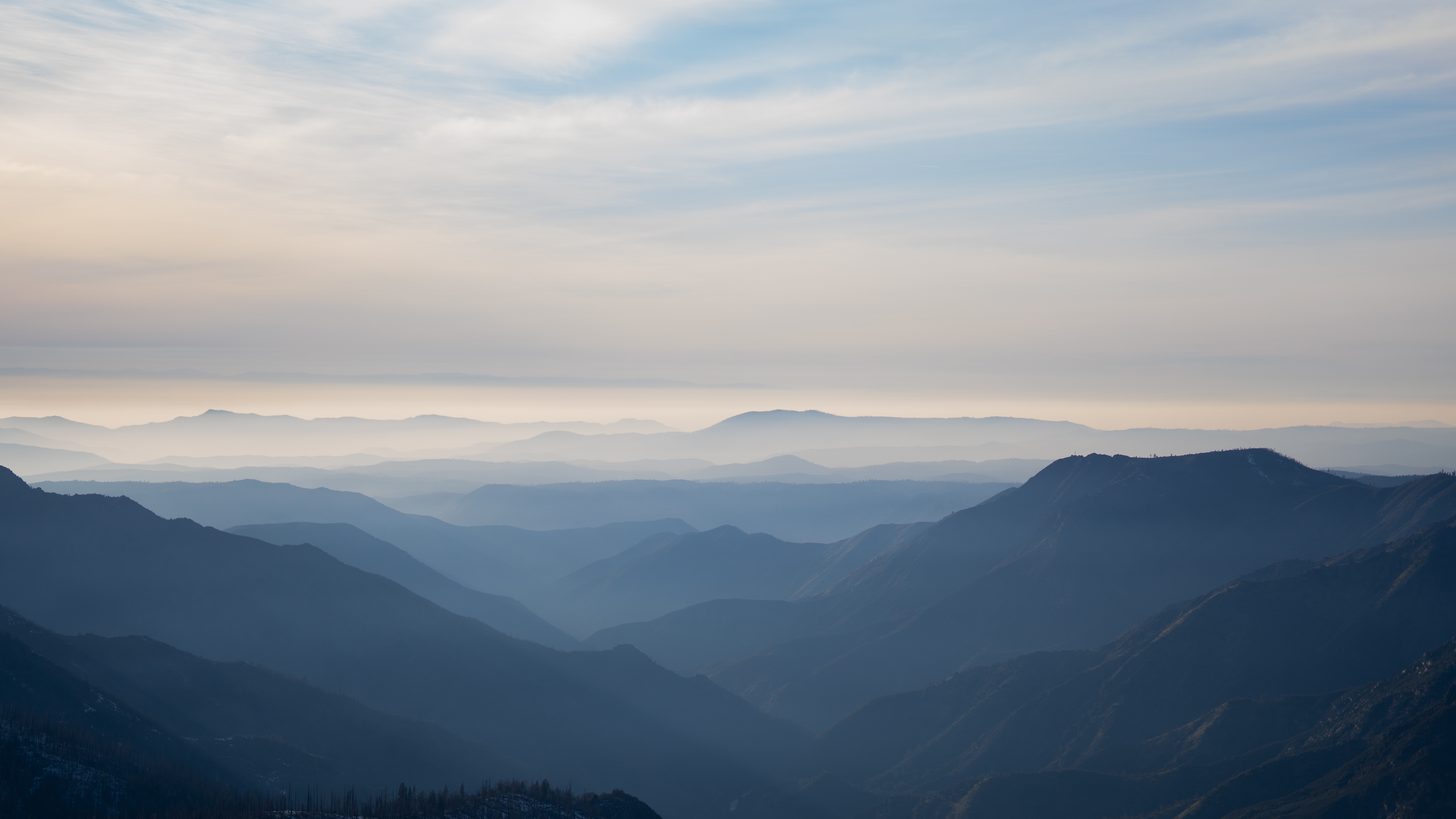 Layered ridgelines fading into morning haze